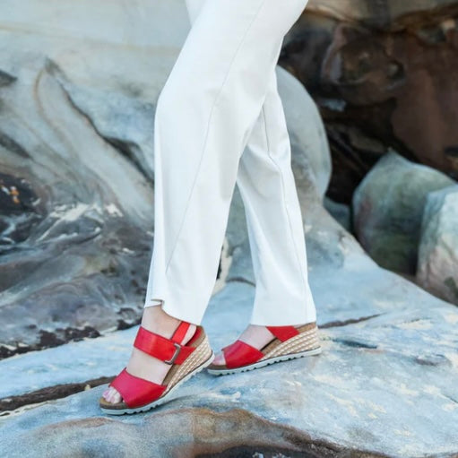 Le Sansa Evita Red sandals featuring stylish strappy design and comfortable flat sole, perfect for casual wear.