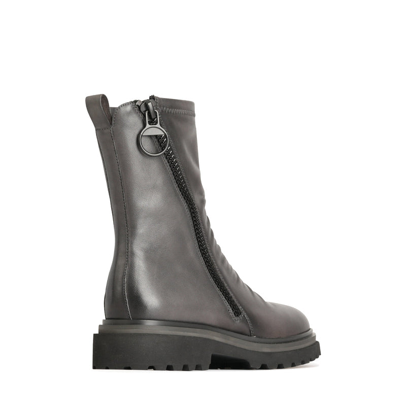 Eos Skarlet Iron boots shown from the back angle, featuring sleek design and sturdy sole, in black leather with detailed stitching.