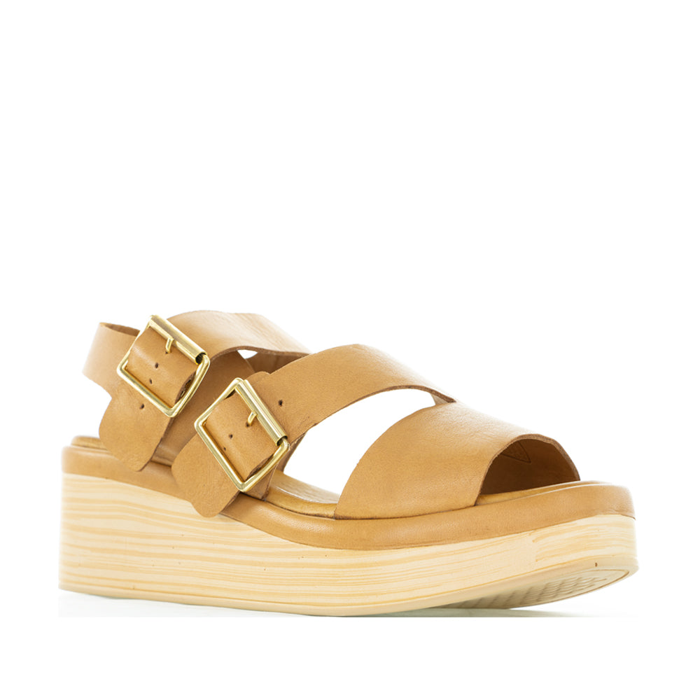 Le Sansa LE SANSA TRI TAN sandals featuring a tan strap design and comfortable flat sole, perfect for casual wear.