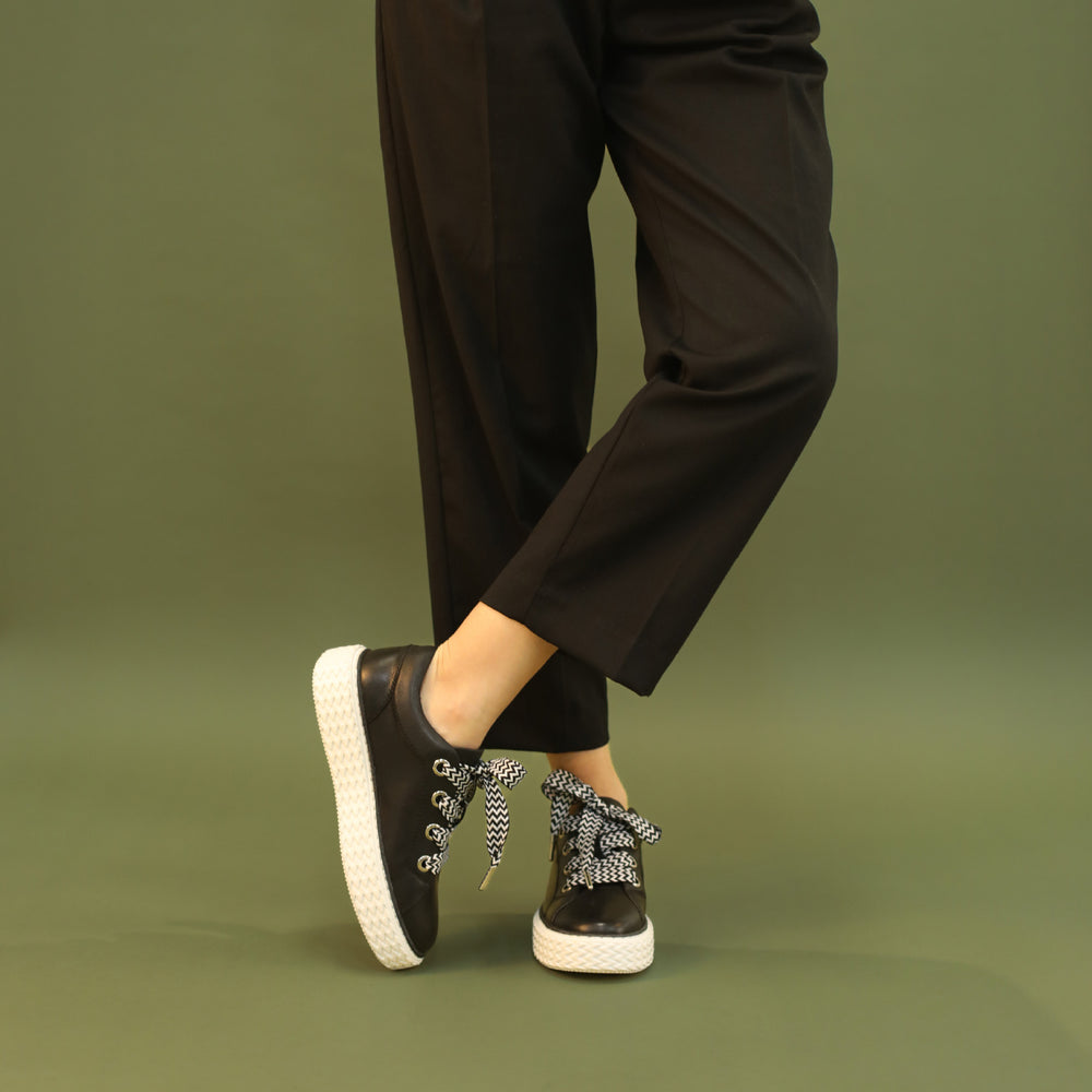Eos Trinsic black sneakers with sleek design and comfortable fit, featuring black laces and modern athletic style.