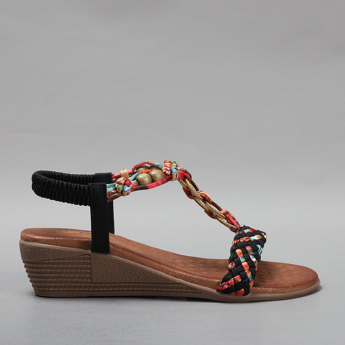Black VS TREADS Ursa sandals shown from the side, featuring a strappy design and cushioned sole for casual wear.