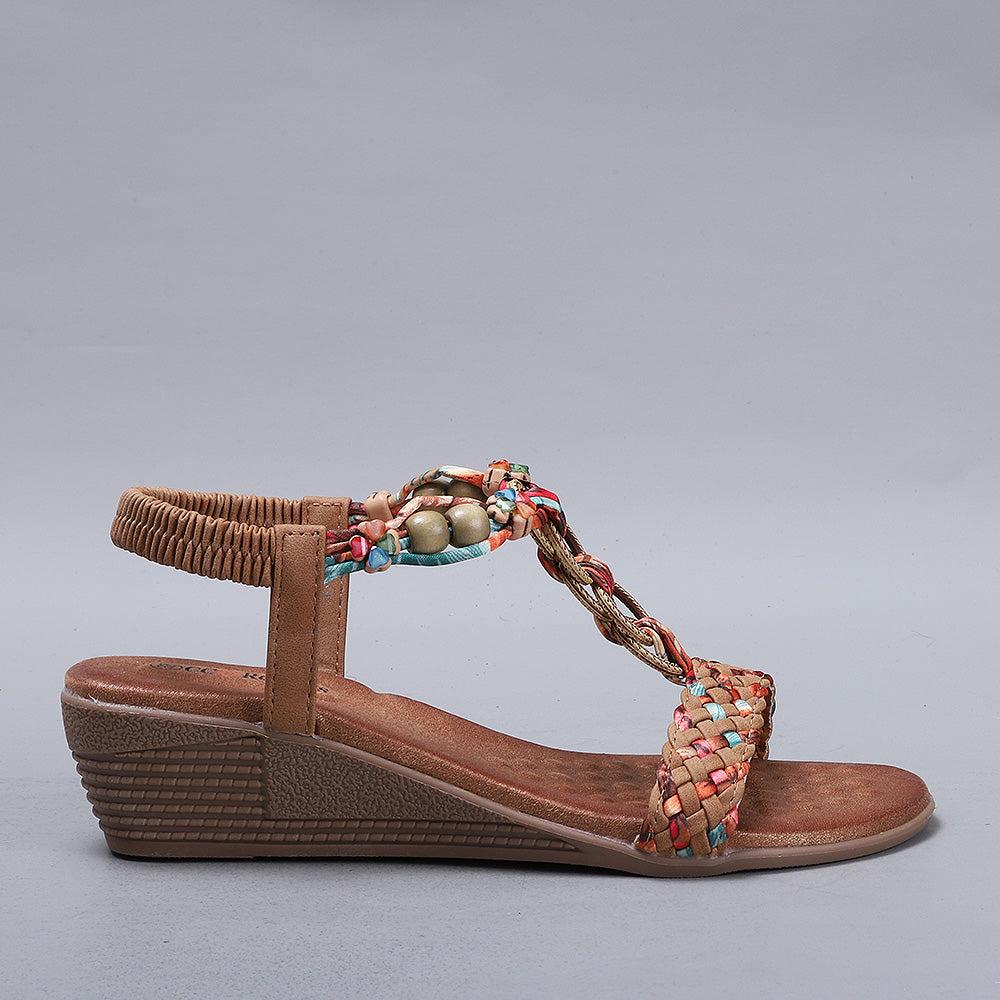 CC Resorts Ursa Tan sandals featuring beige straps and cushioned soles, displayed on a neutral background.