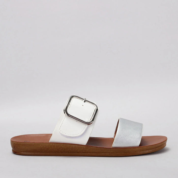 VS Treads Velma white and silver flat shoes with sleek design and comfortable fit, showcasing side view of the footwear.