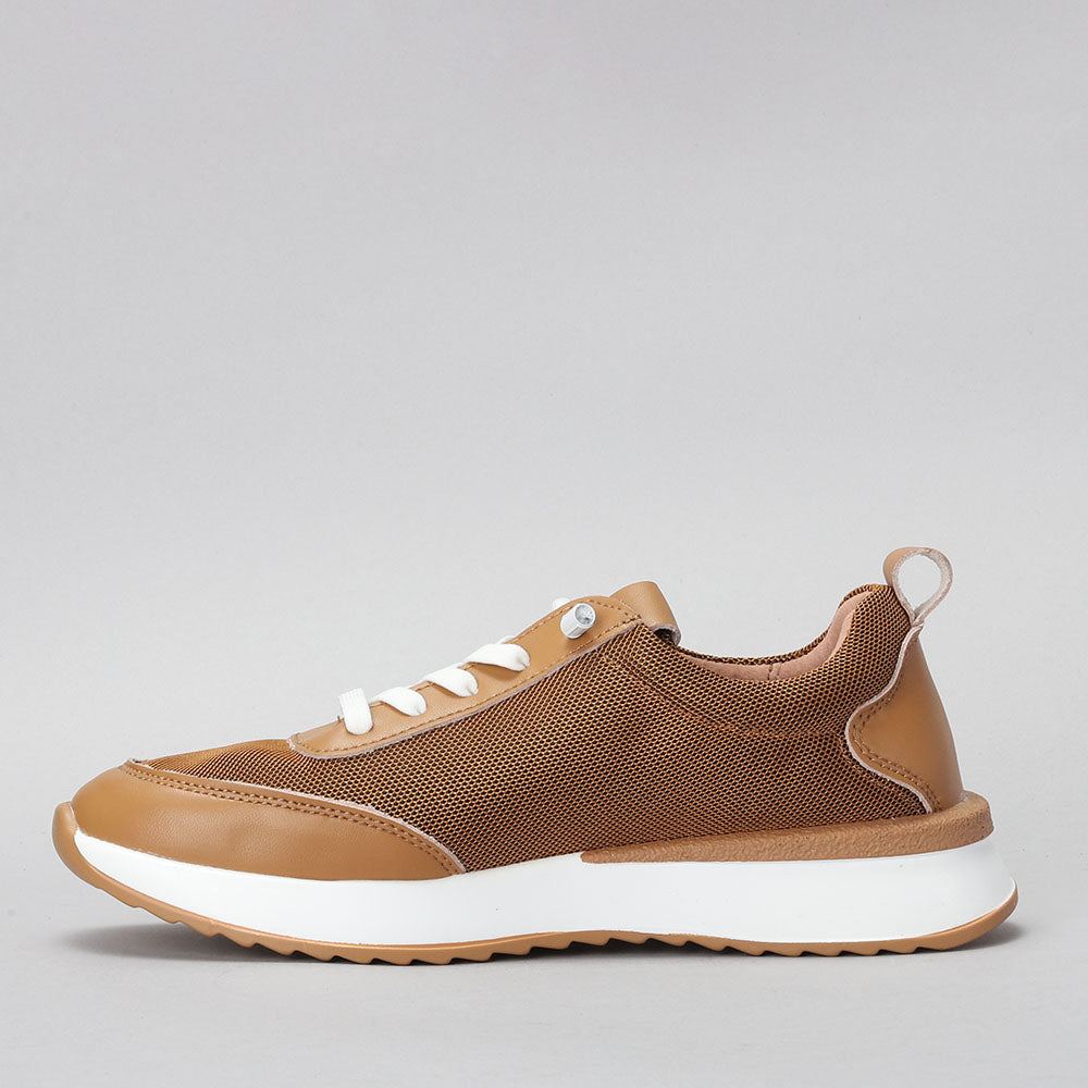 CC Resorts Walky Tan sneakers featuring a casual design with tan-colored fabric and white rubber soles.