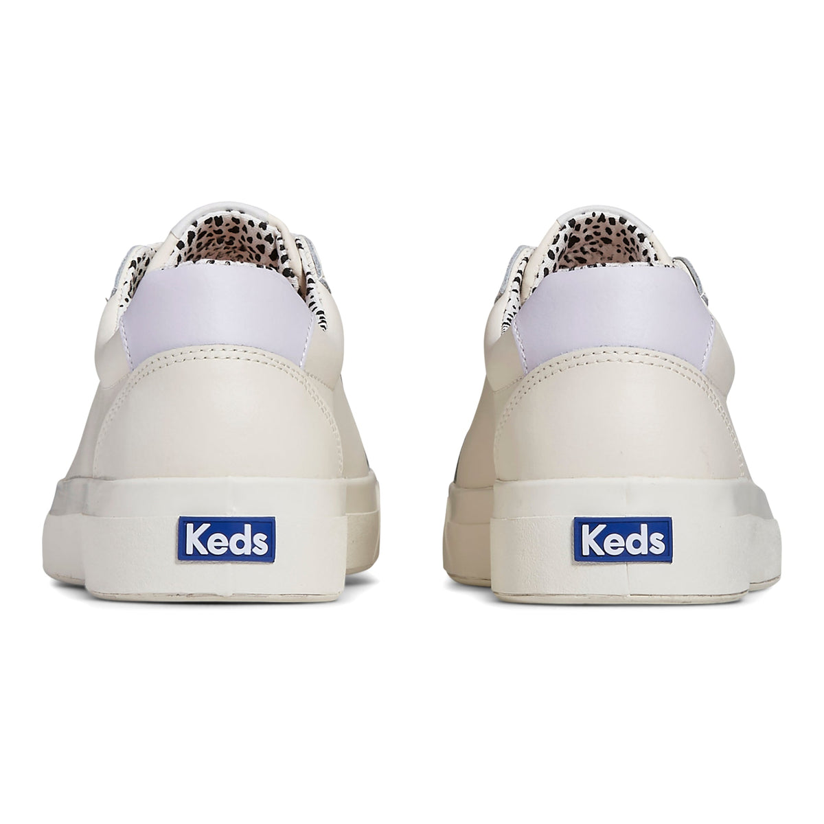 KEDS Pursuit leather sneakers in cream and multicolor design, featuring a casual slip-on style and textured sole.