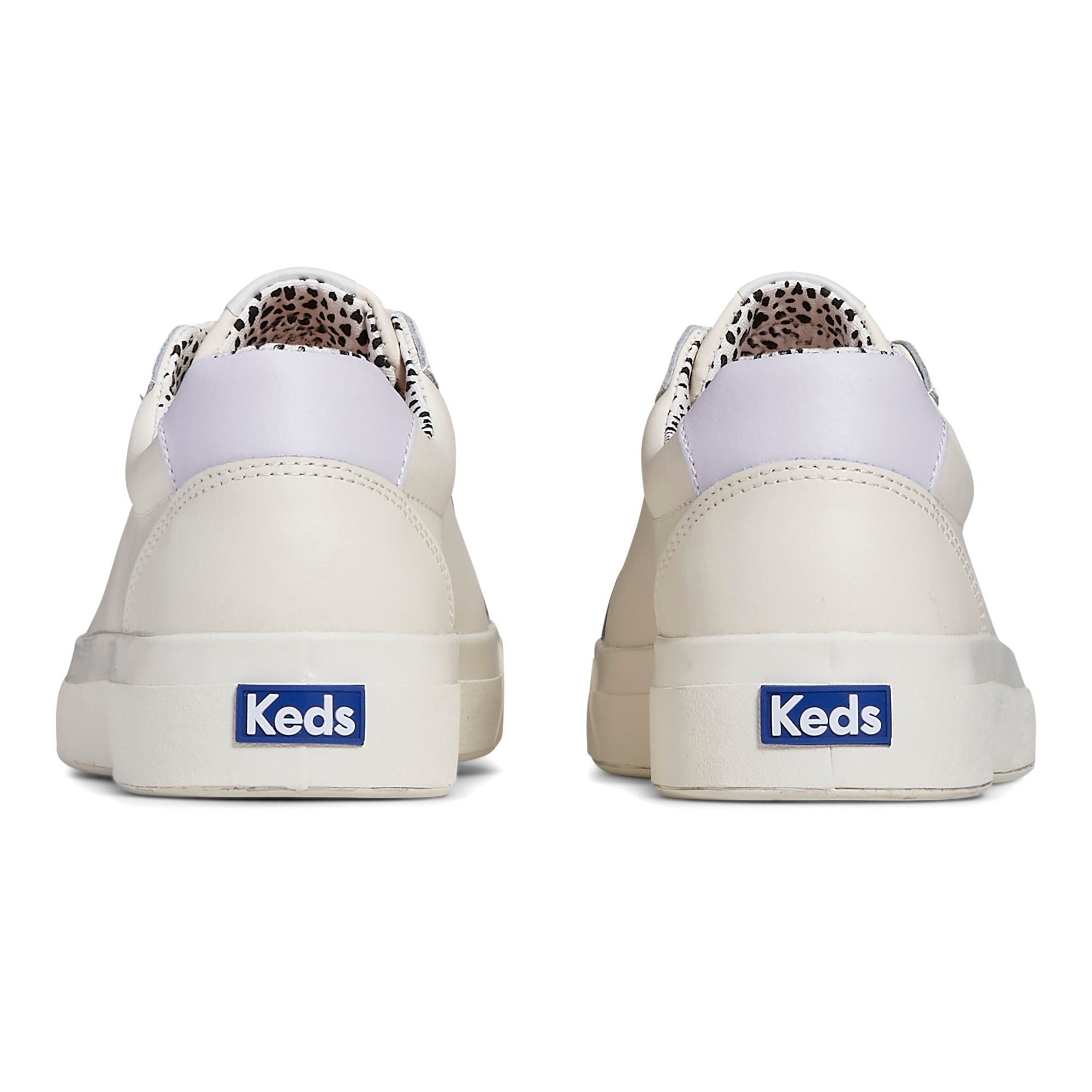 KEDS Pursuit leather sneakers in cream and multicolor design, featuring a casual slip-on style and textured sole.