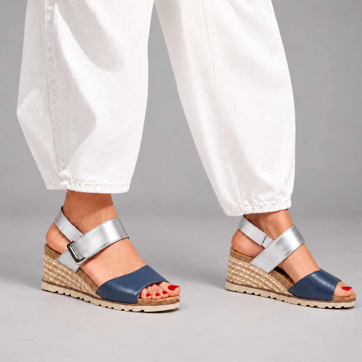Le Sansa Evita navy and silver sandals paired with white jeans, showcasing stylish summer footwear.