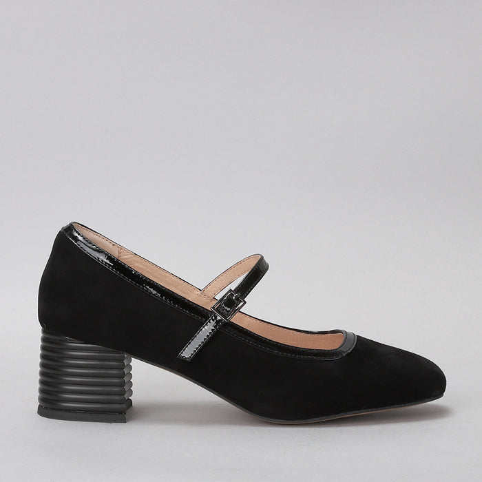 Le Sansa Zafira black suede heels shown from a side view, featuring pointed toes and elegant design.
