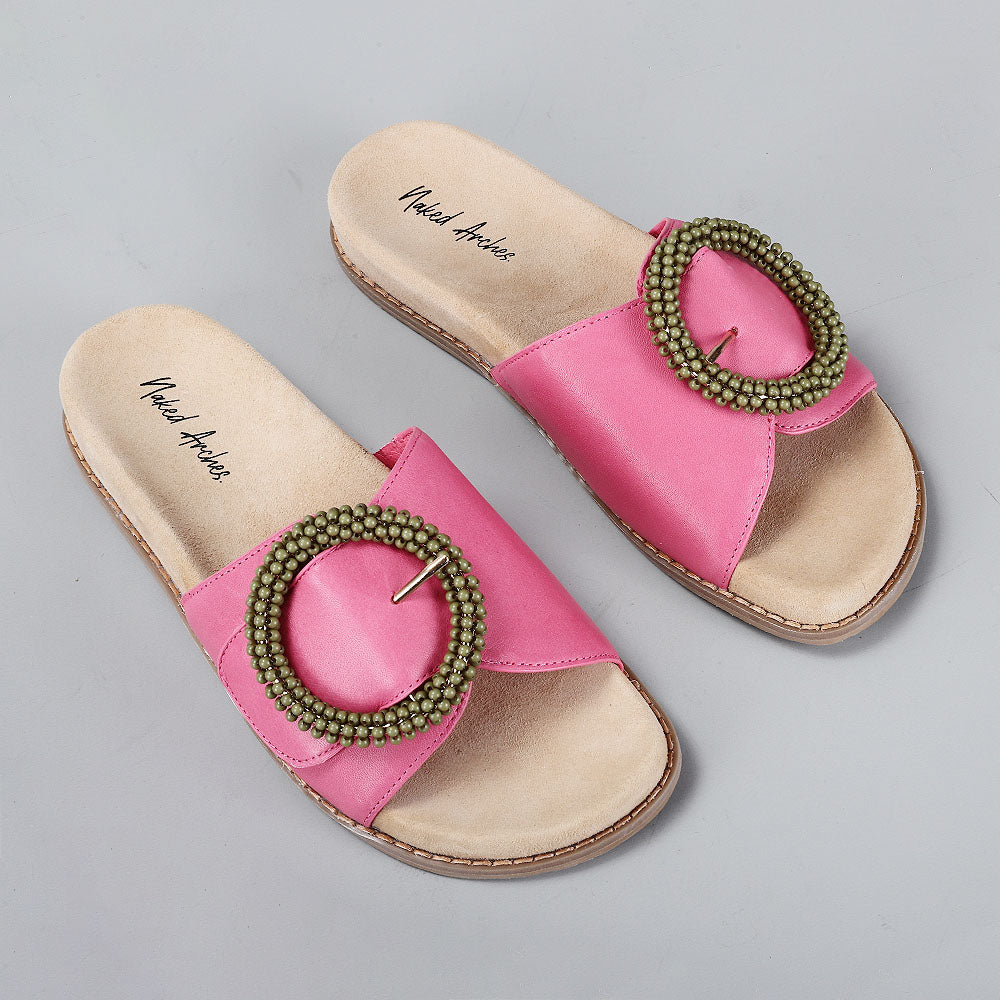 Naked Arches Zoya hair slip-ons shown from an angled view, featuring stylish design and natural texture.