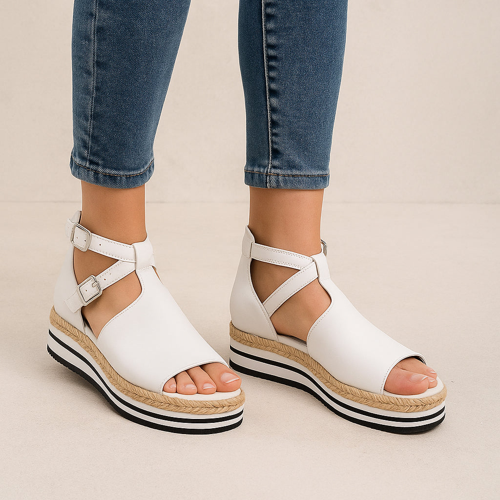 White Django & Juliette Alexys sandals with open toe and ankle strap, stylish and comfortable footwear for summer.