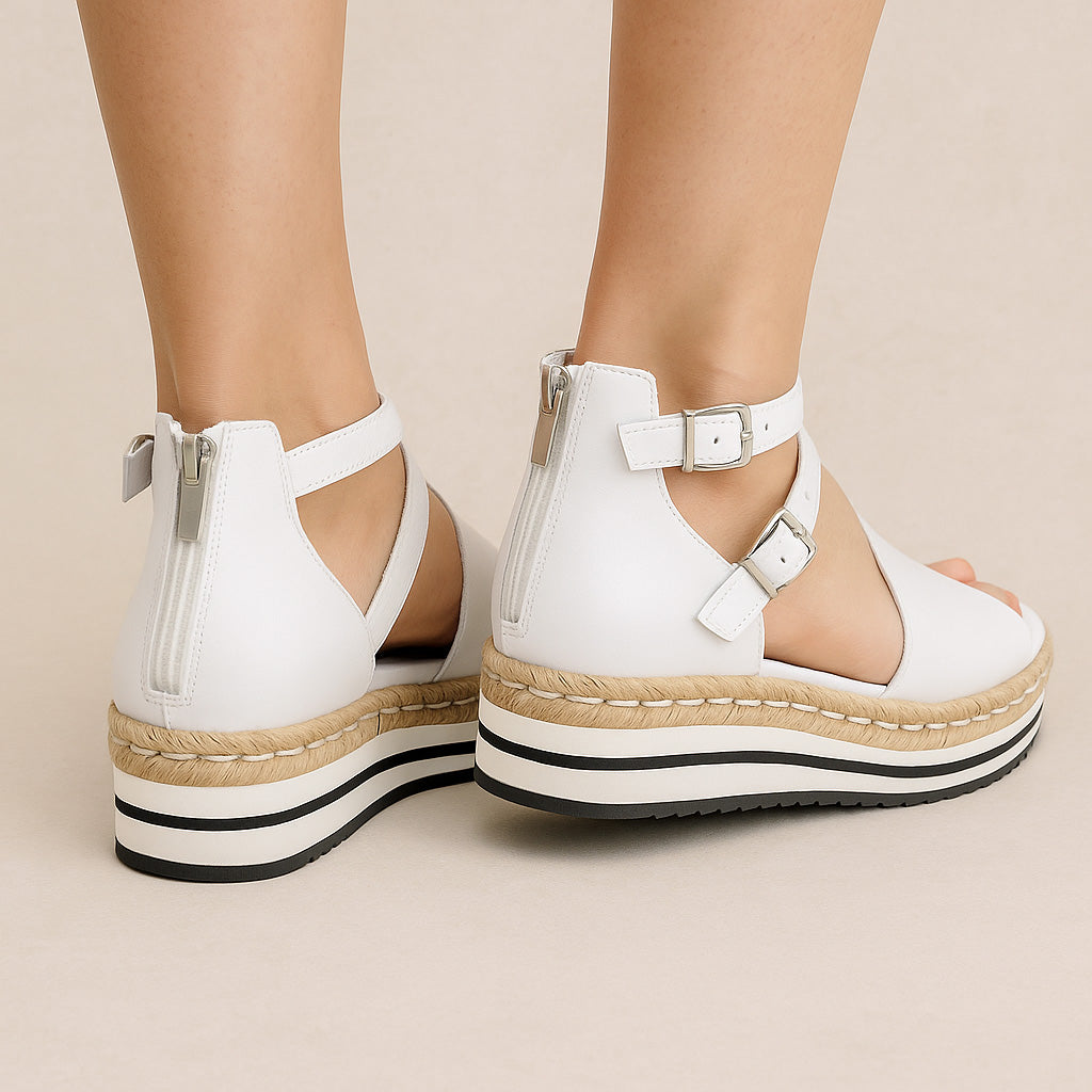 Django & Juliette Alexys white sandals with open toe design and ankle straps, stylish footwear for warm weather.