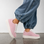 Pink NAKED ARCHES Azealia sneakers with sleek design and white sole, featuring the brand logo on the side.