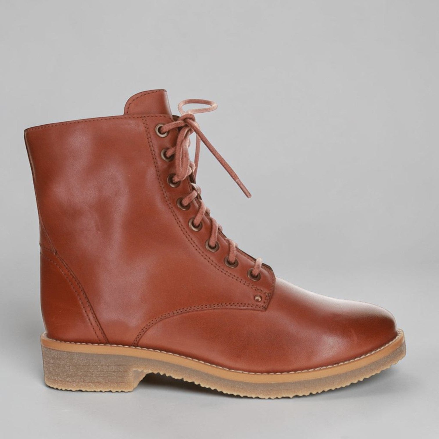 LE SANSA Besty Tan boots featuring a sleek design, ankle-high style, and tan leather finish, displayed on a neutral background.