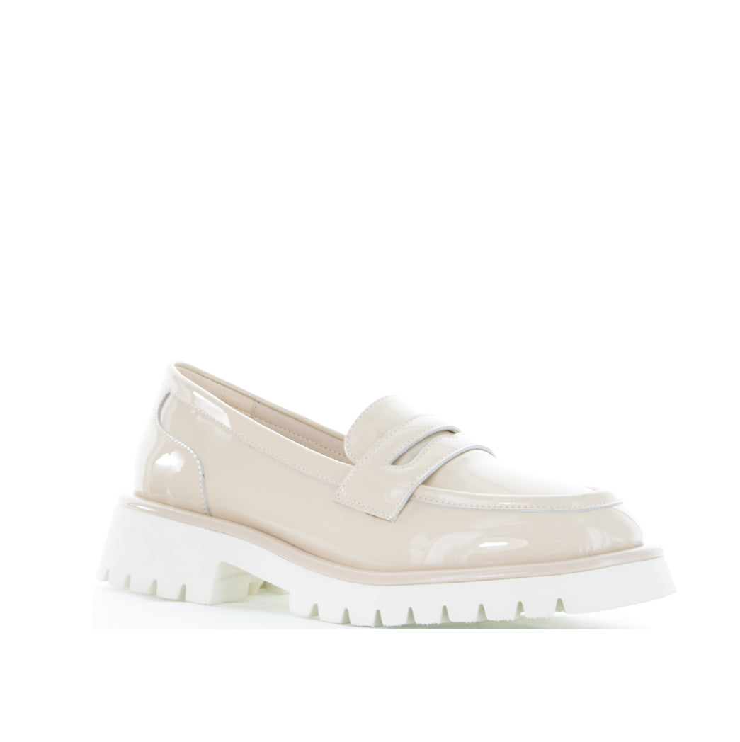 Le Sansa nude patent loafers featuring a sleek bow detail, stylish and comfortable for casual or dressy outfits.