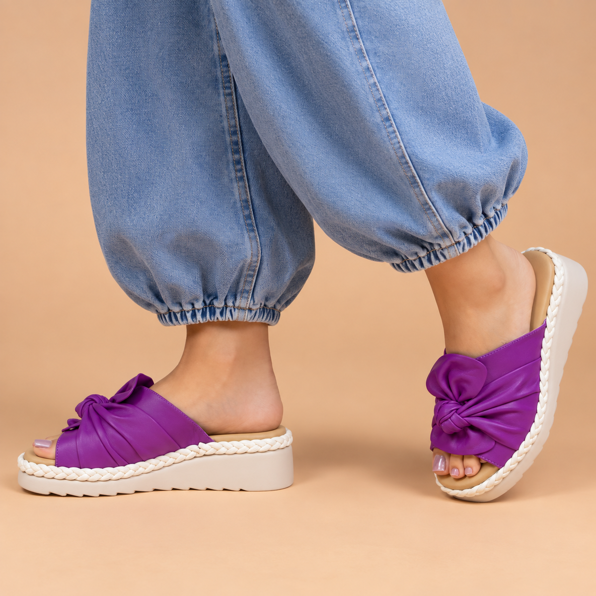Le Sansa Eudore purple slip-on shoes with a sleek design and comfortable fit, shown in a close-up view.