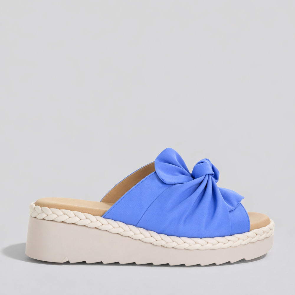 Royal blue Le Sansa Eudore slip-on shoes with a sleek design, featuring comfortable fabric and casual style.