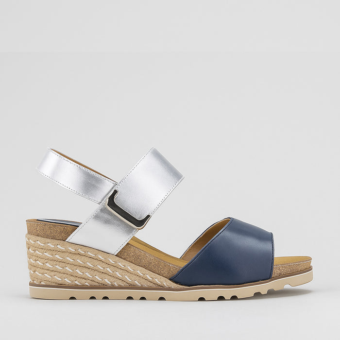 Le Sansa Evita navy silver sandals with open toes and ankle straps, featuring metallic silver accents and stylish design.