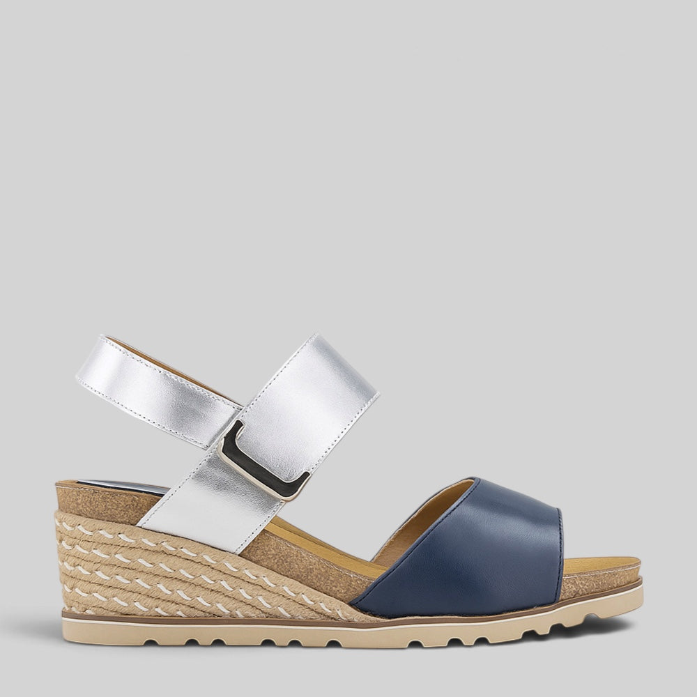 Le Sansa Evita navy and silver sandals with sleek straps and stylish design, perfect for casual or dressy occasions.
