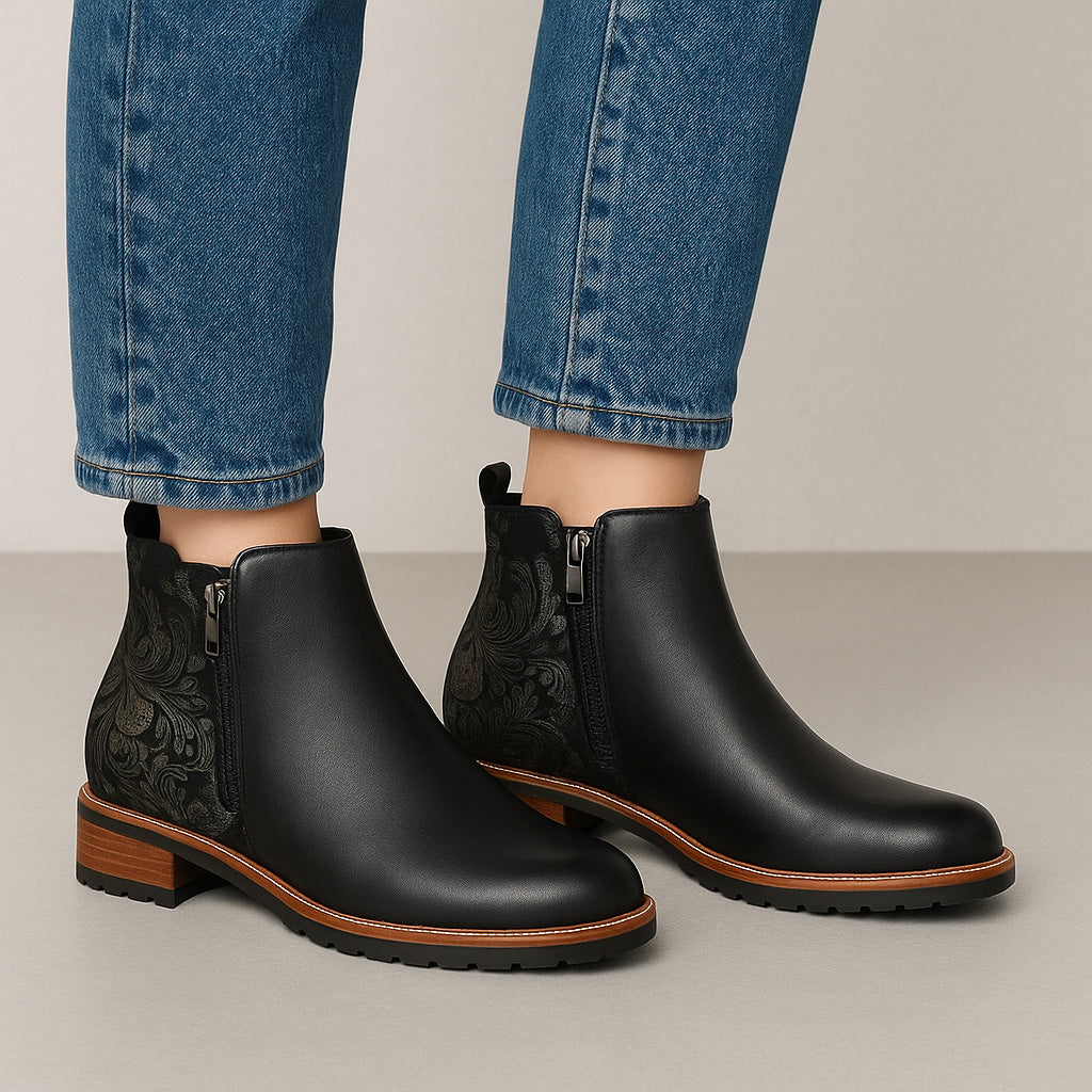Le Sansa black print boots featuring a stylish fig pattern, showcasing a sleek design with laces and a sturdy sole.