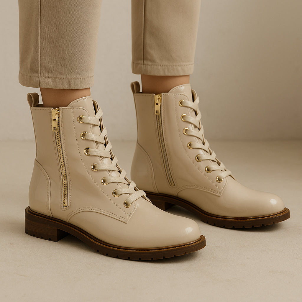 Le Sansa nude patent boots with sleek, pointed toes and high heels, showcasing shiny finish and stylish design.