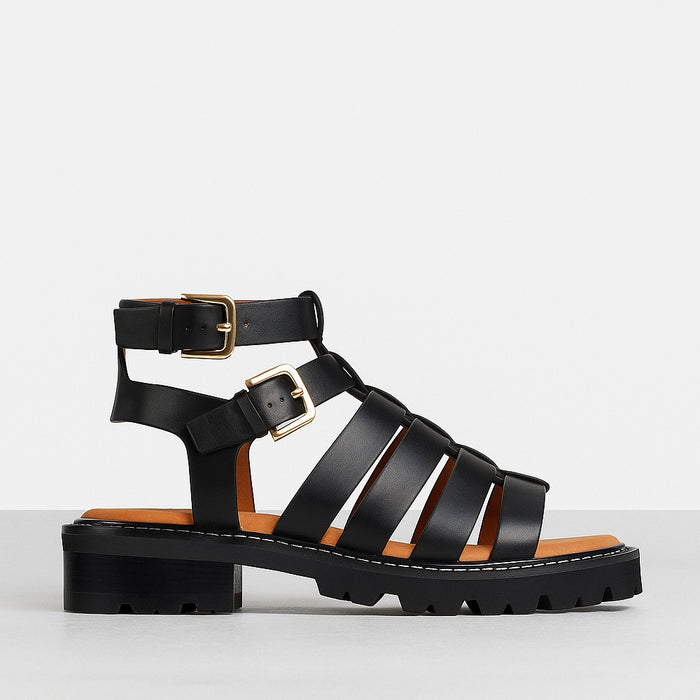Eos Gizelle Black sandals featuring a sleek design with ankle straps and open toe, perfect for casual or dressy summer wear.