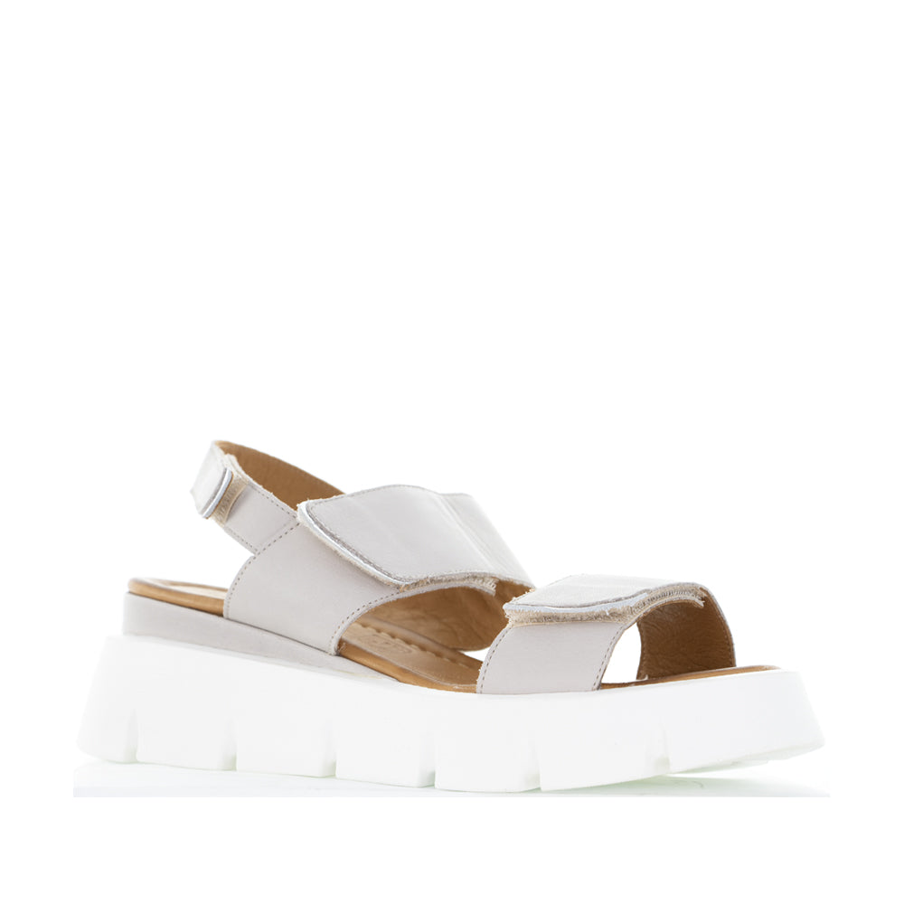 Le Sansa silver grey sandal handle featuring sleek design and textured material, close-up view of the strap detail.