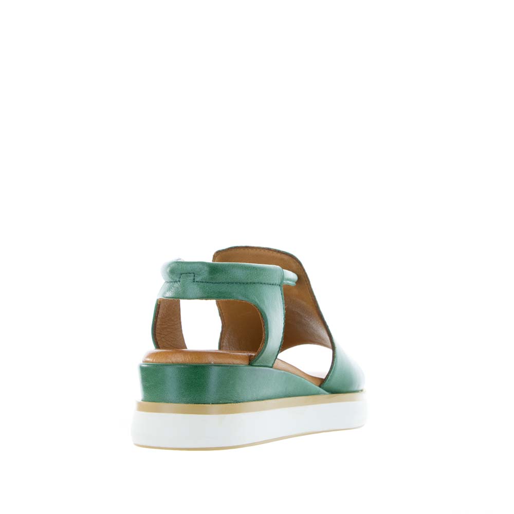 Le Sansa Hide Pine sandals featuring leather straps and a comfortable flat sole, stylish for casual wear.