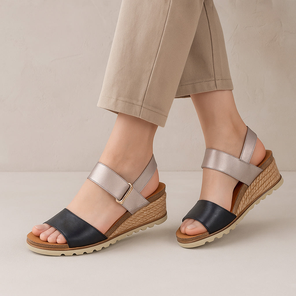 Le Sansa Evita black champagne sandals featuring stylish straps and a comfortable design for casual or dressy occasions.
