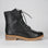 Black LE SANSA BESTY boots with sleek design and rounded toe, showcased on a neutral background.
