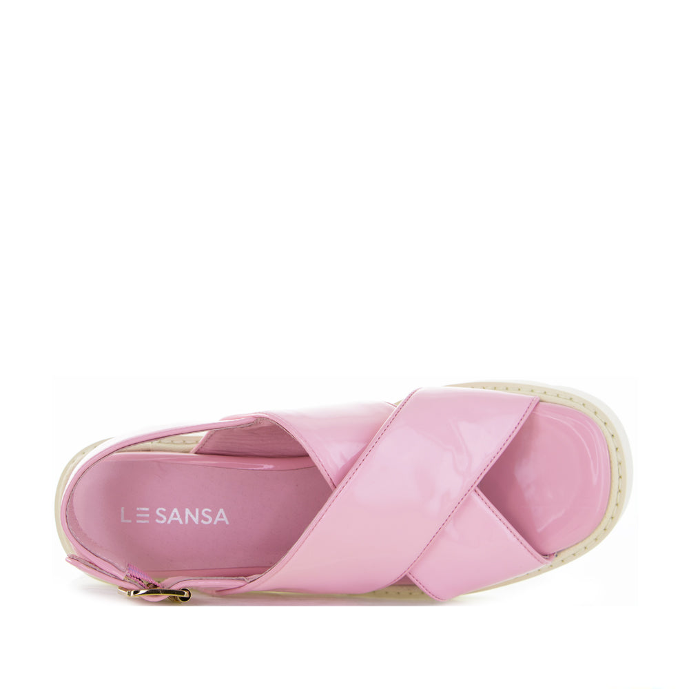Pink LE SANSA France sandals with open toe design and ankle straps, stylish footwear for casual or dressy occasions.