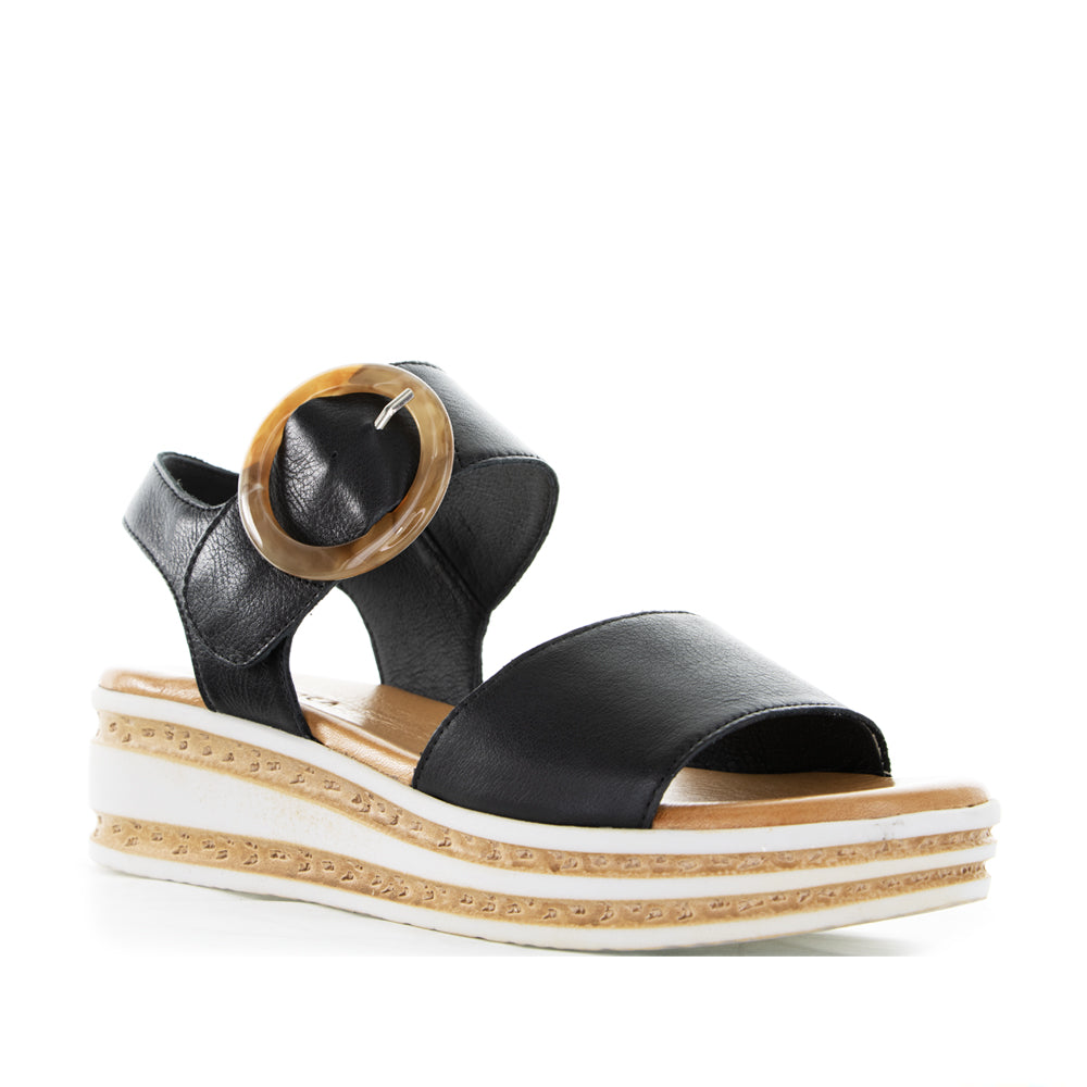 Black Le Sansa Sansa Guard sandals with adjustable straps and cushioned soles, designed for comfortable casual wear.