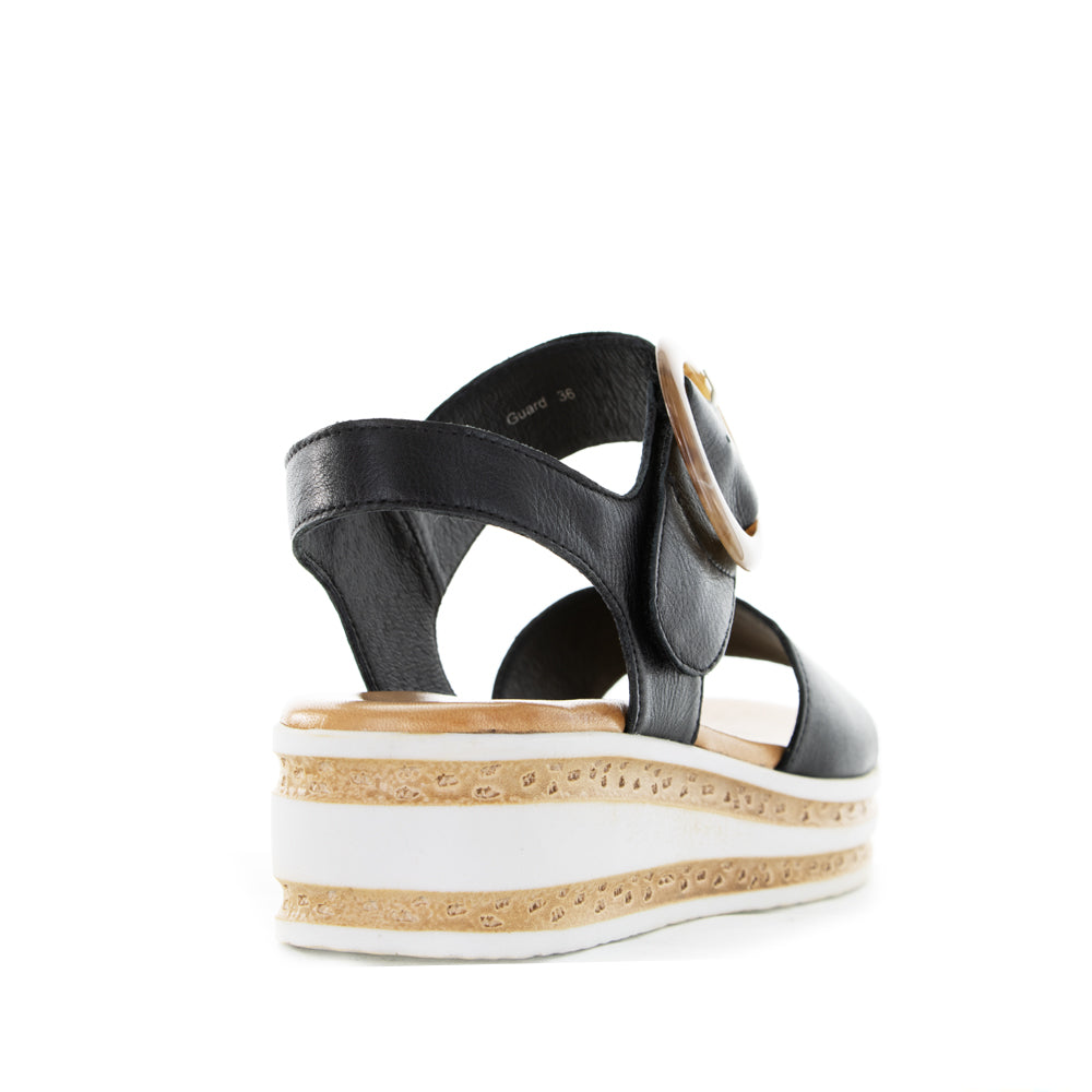 Black Le Sansa Sanda Guard sandals with open-toe design and ankle straps, featuring a sleek and stylish look.