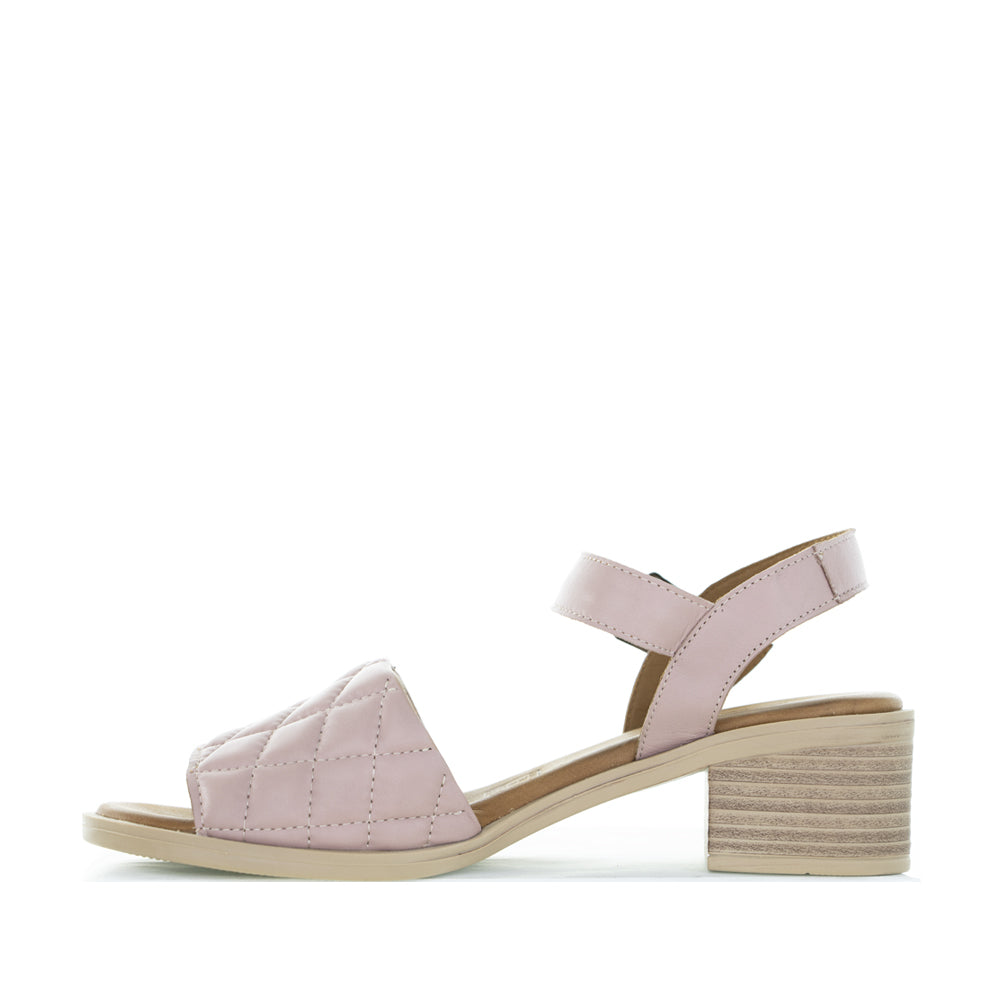 Le Sansa Lincoln Skin sandals featuring a sleek design with neutral-colored straps and comfortable flat soles.