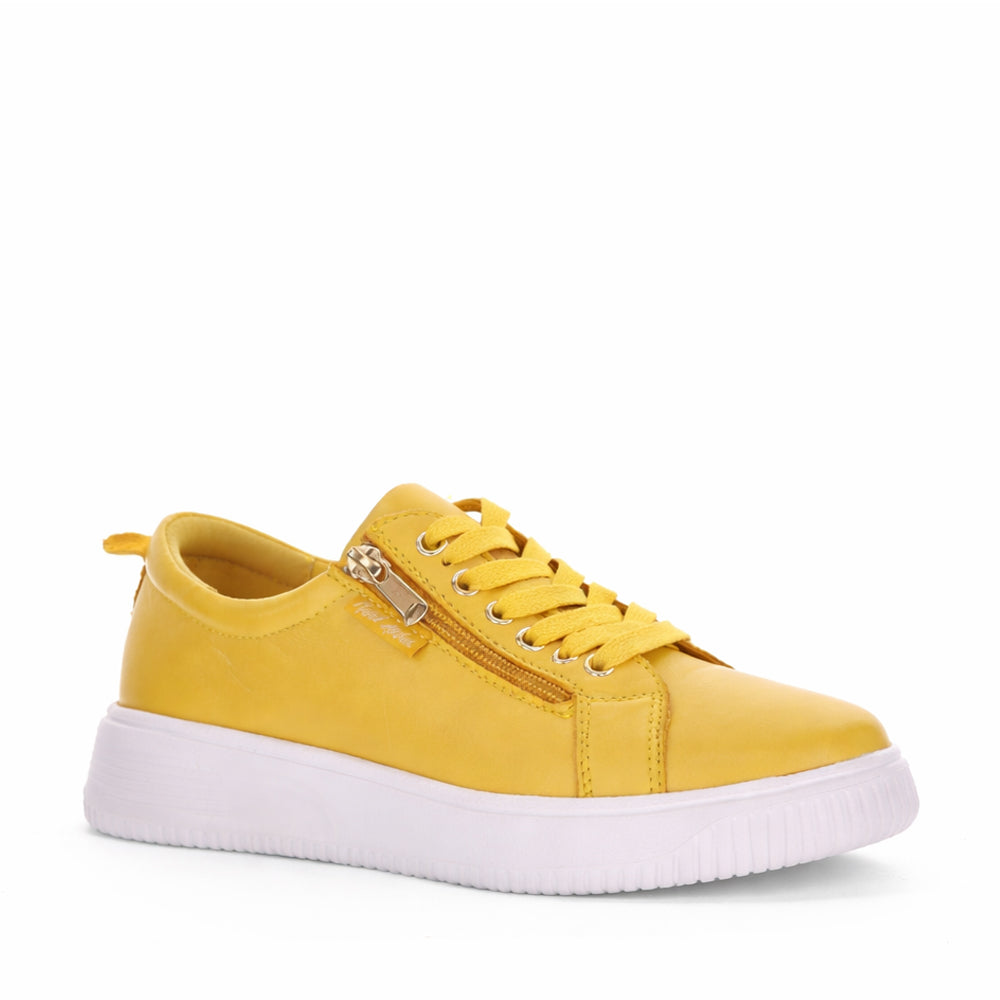 NAKED ARCHES NELLY MUSTARD sneakers featuring mustard yellow color and stylish, casual design with lace-up closure.
