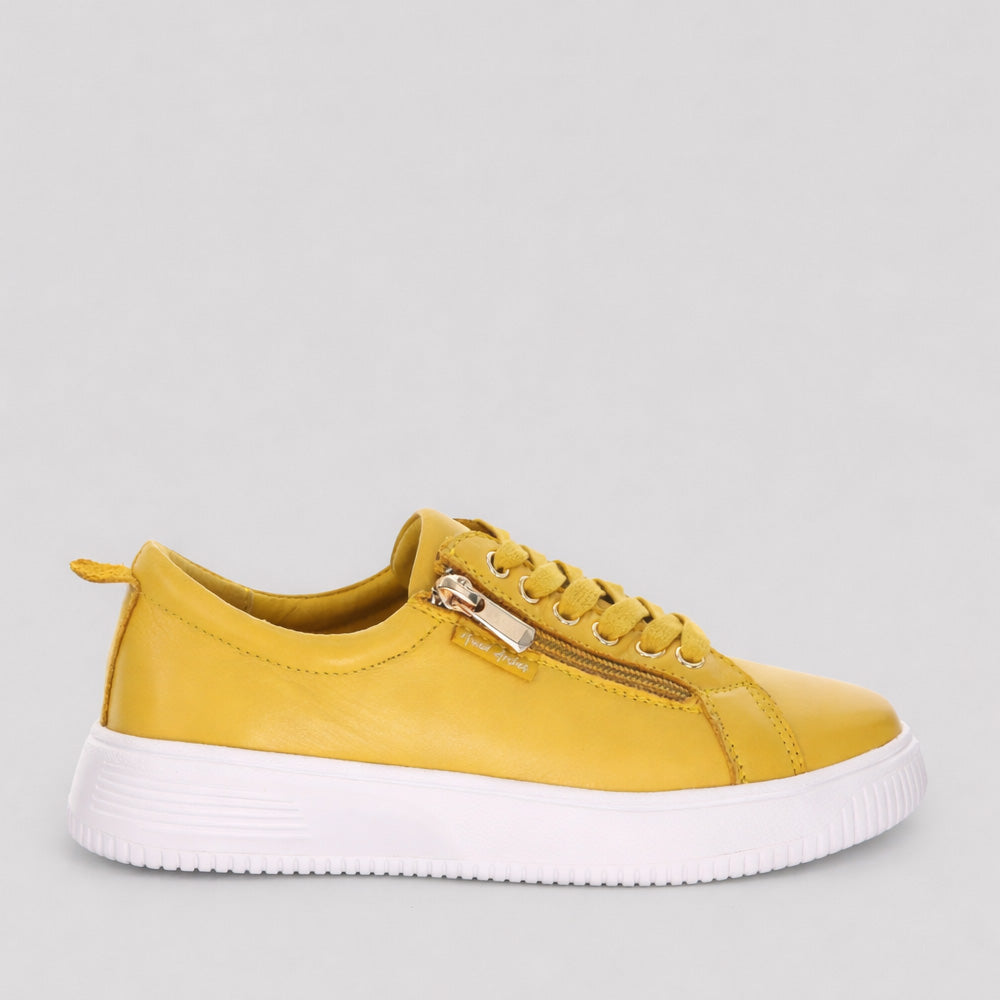 Naked Arches Nelly Mustard sneakers with yellow and white colorway, stylish casual footwear on a clean background.