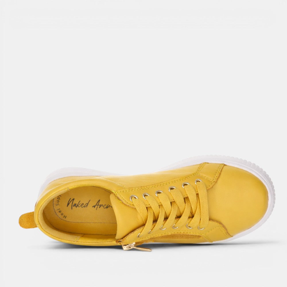 Naked Arches Nelly Mustard sneakers featuring a mustard yellow color, casual lace-up design, and stylish comfort.