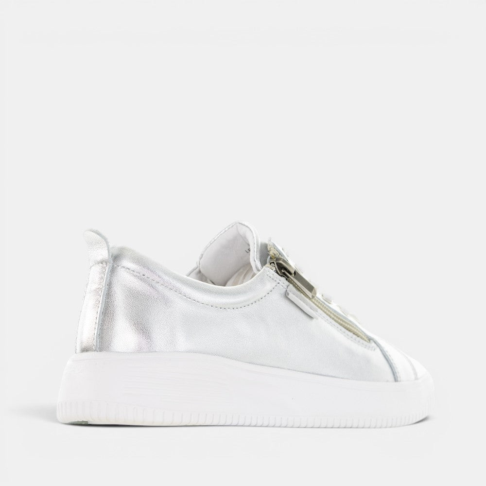 Silver NAKED ARCHES NELLY sneakers with sleek design and cushioned sole, showcasing stylish footwear by NAKED ARCHES.
