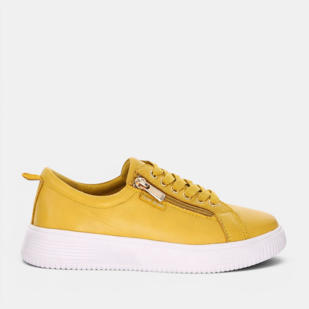 Naked Arches Nelly Mustard sneakers featuring mustard yellow color and casual design on a white background.