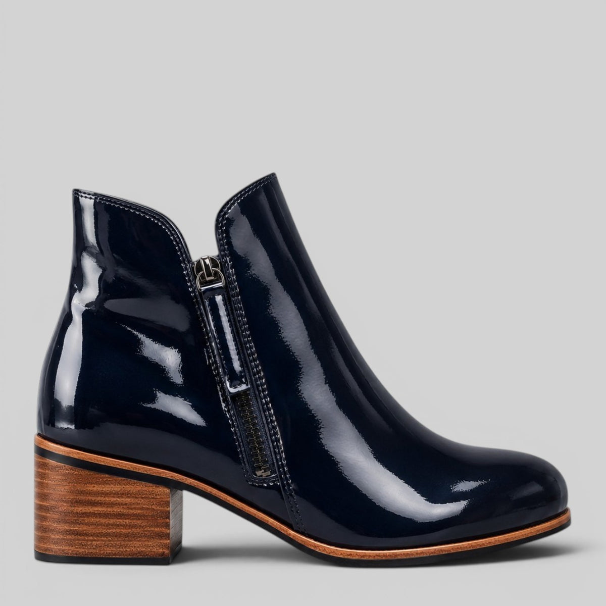 Naked Arches Oxley Navy Patent Boots showing sleek navy patent leather with a rounded toe and stylish ankle height.