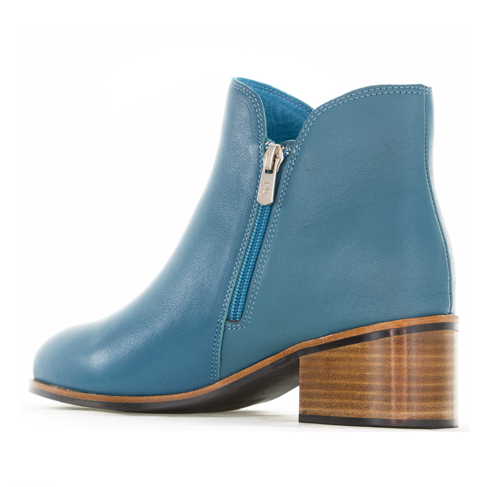 Naked Arches Oxley turquoise boots with suede finish and ankle-length design, featuring a rounded toe and low block heel.