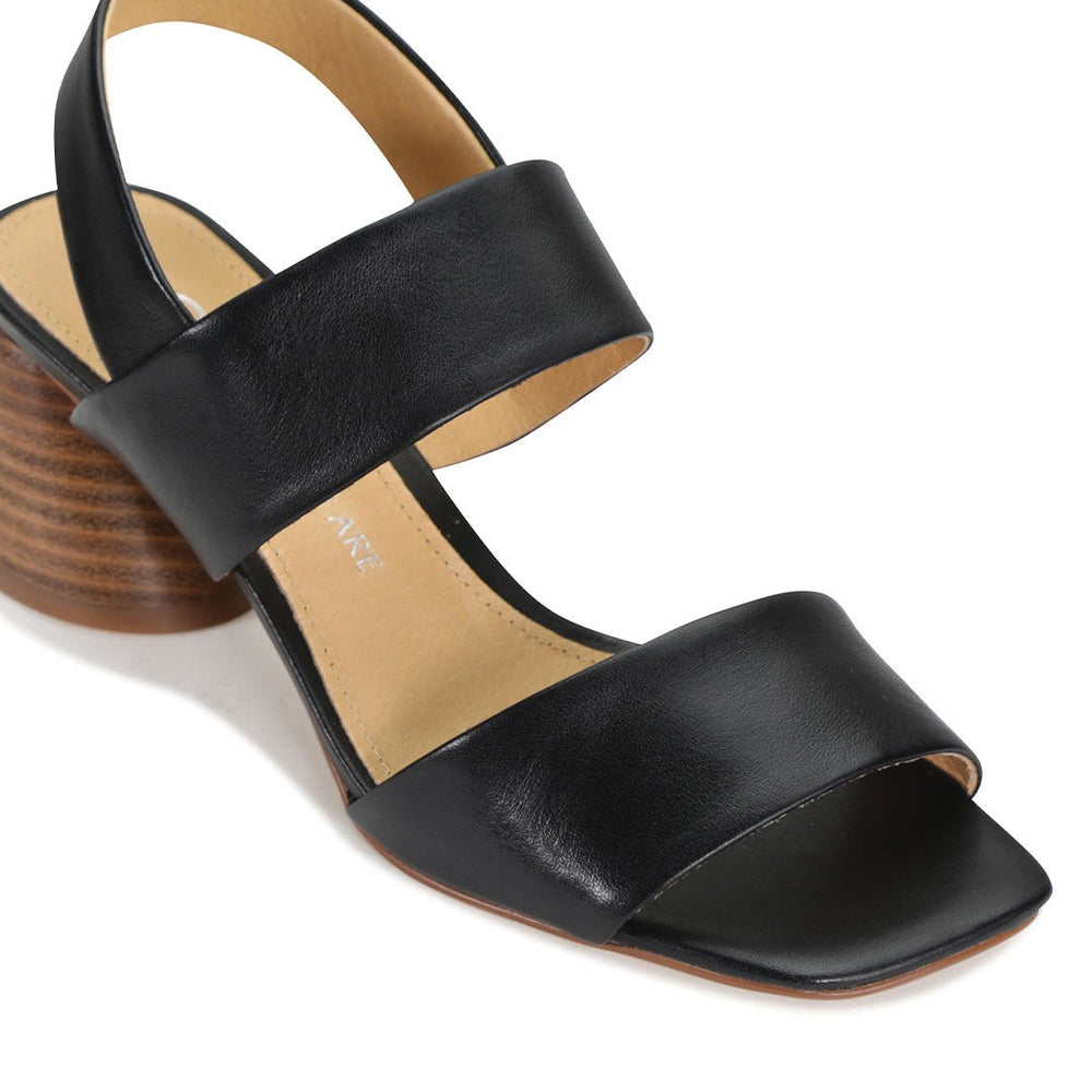 Black EOS Peto sling-back sandals with open toes and stylish design, perfect for casual summer wear.