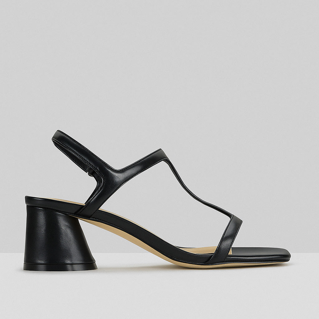 Eos Petras Black heels featuring sleek design and pointed toes, worn on a model's feet.