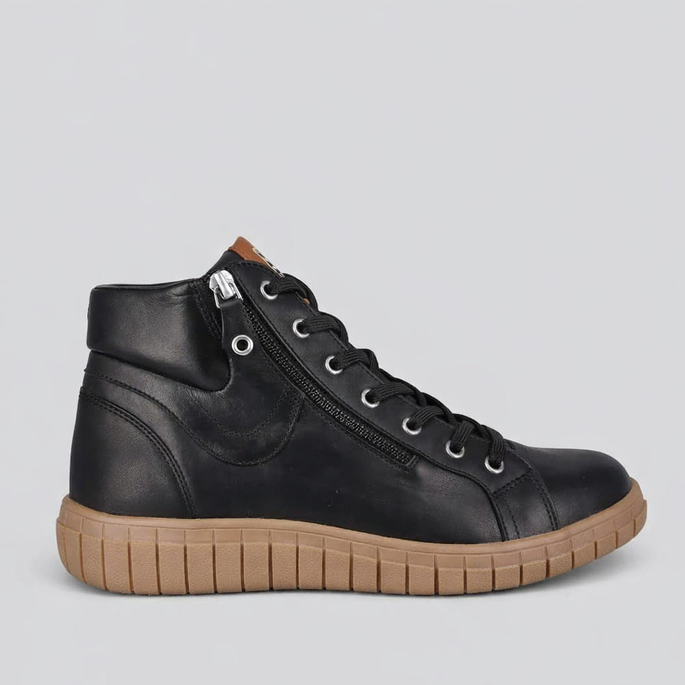 Black Cabello Reagan boots with sleek leather design and pointed toes, showcasing stylish footwear for women.