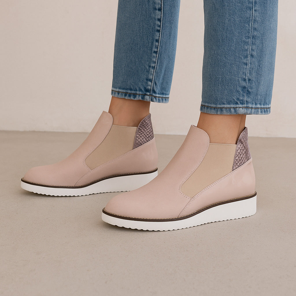 Le Sansa Rally Blush Rosegold boots with sleek design and blush pink color, featuring stylish laces and a comfortable sole.