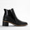 Black LE SANSA Refine boots with sleek design and pointed toes, displayed on a neutral background.