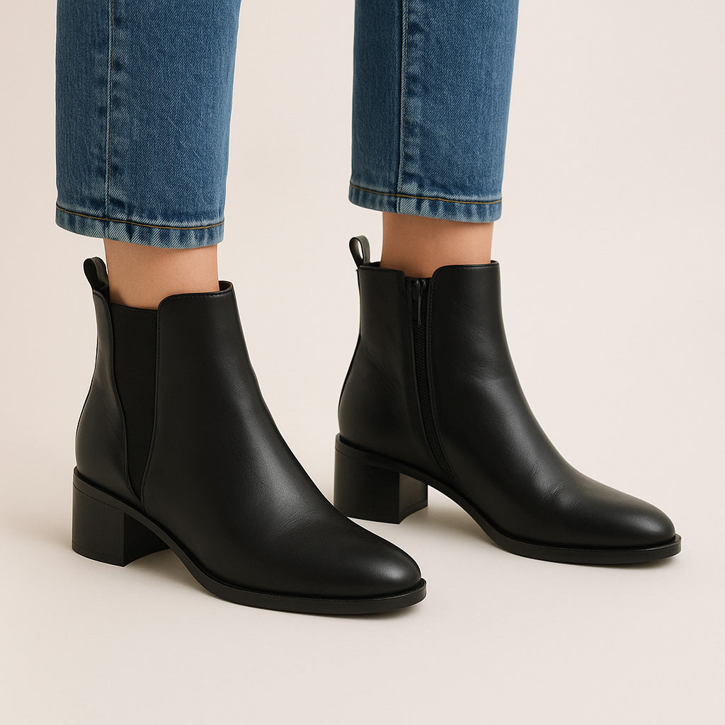 Black LE SANSA Sansa Ring boots featuring sleek design and sturdy sole, perfect for stylish casual wear.