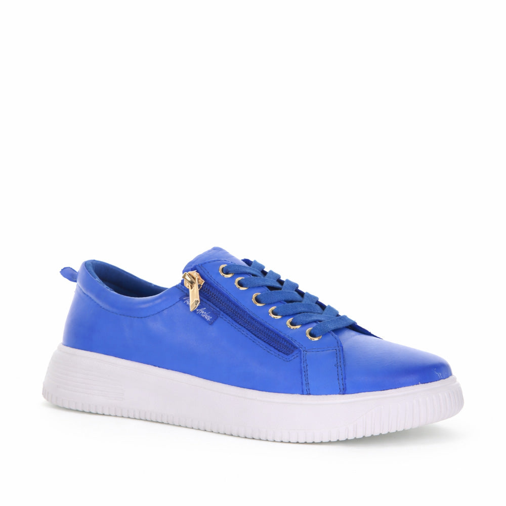 Naked Arches Nelly Royal Blue sneakers with smooth fabric upper and white rubber sole, front view showing stylish design.