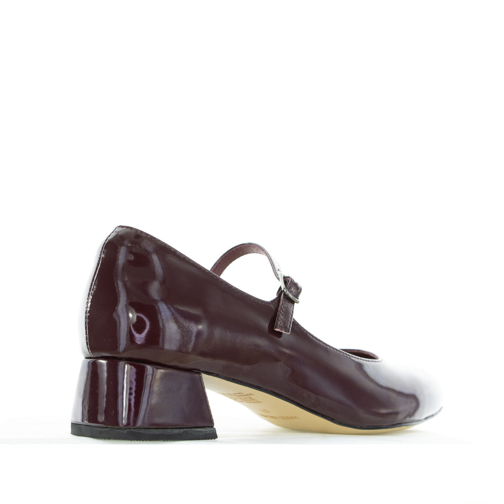 NAKED ARCHES Merlot Patent Sandals featuring sleek, glossy straps and comfortable flat sole for stylish summer wear.