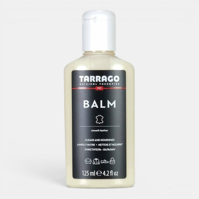 Zeke Collection Tarrago leather balm shoe care product in a shopping setting, showcasing packaging and application tools.