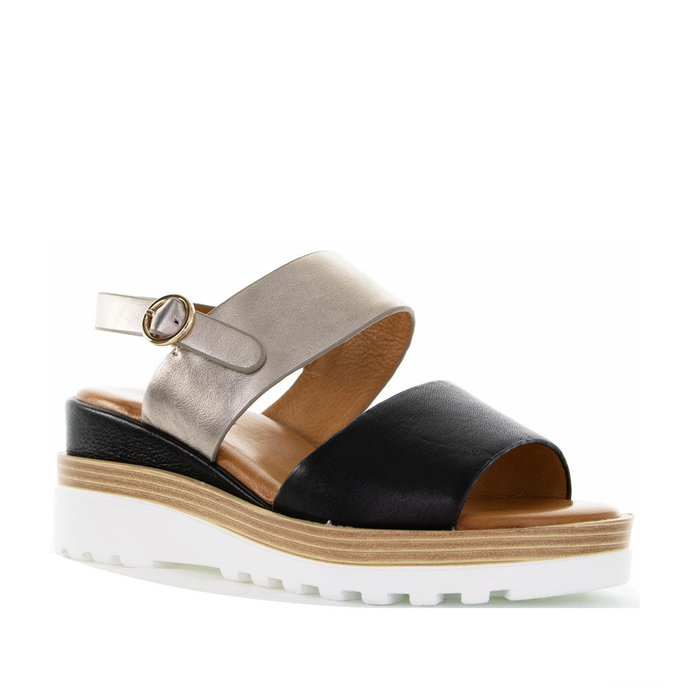 Le Sansa Tess Black Champagne sandals with sleek black straps and subtle champagne accents, stylish and comfortable footwear.
